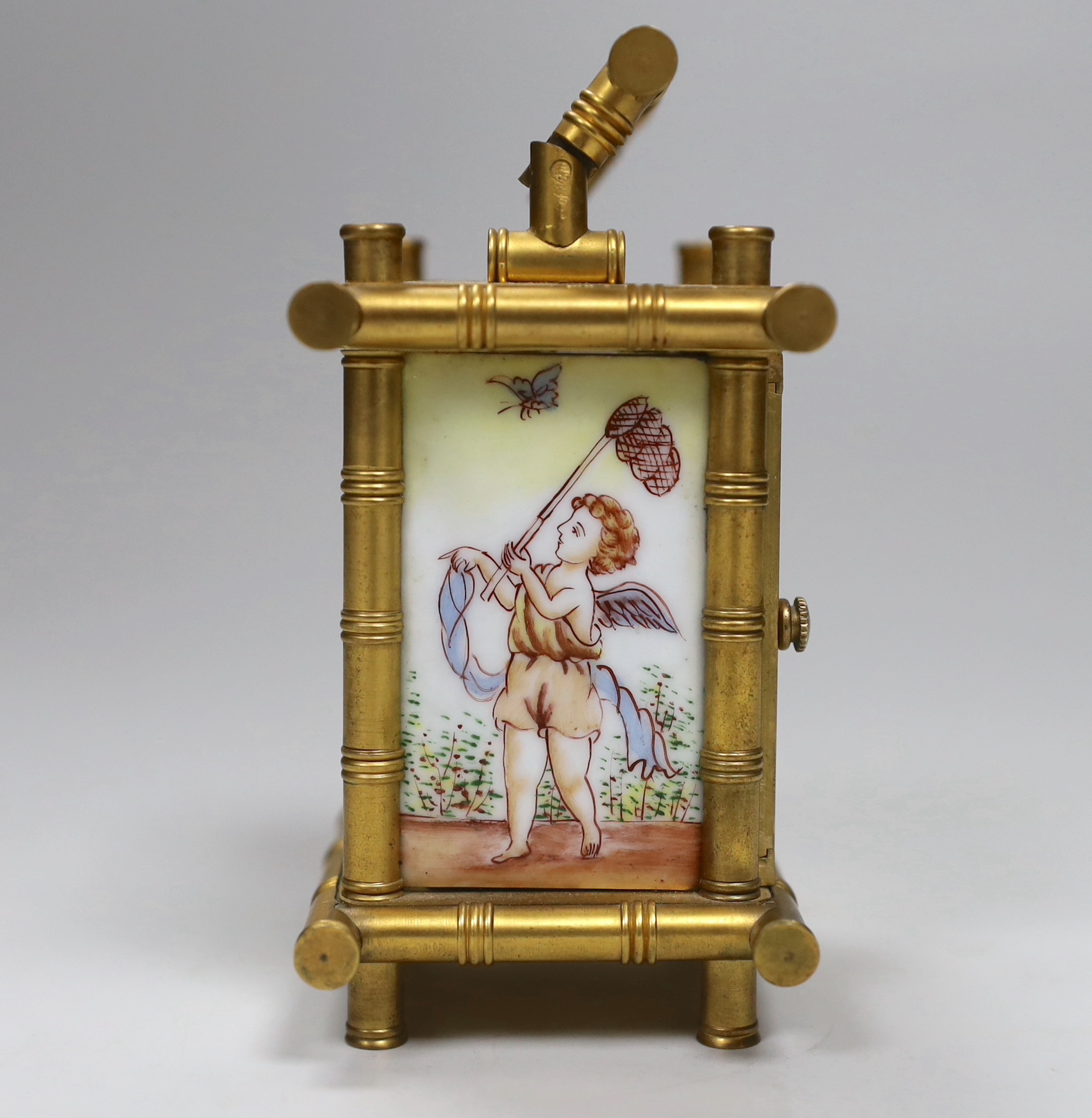A French bamboo design carriage clock, with three porcelain putti decorated sides, by Elliot & Son, London, 9.5cm high